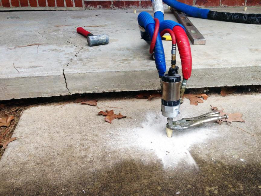 injecting high-density polyurethane foam beneath a sunken concrete